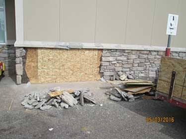 Plywood sheathing patched into the wall after the framing behind the broken stone was rebuilt