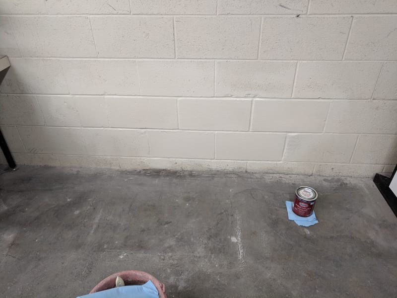 Repaired block wall painted to match the rest, with no sign of where the damage was
