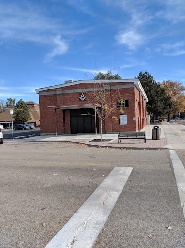 The Meridian Masonic Temple, a red brick building with the square and compass emblem, seen from the street