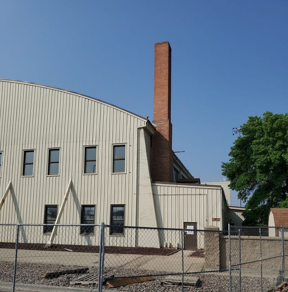 Tall brick chimney stack rising above Hangar 208 at Mountain Home Air Force Base