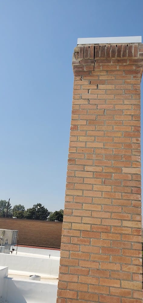 Cracked mortar and loose bricks below the cap of the Owyhee County Courthouse chimney, Murphy, Idaho