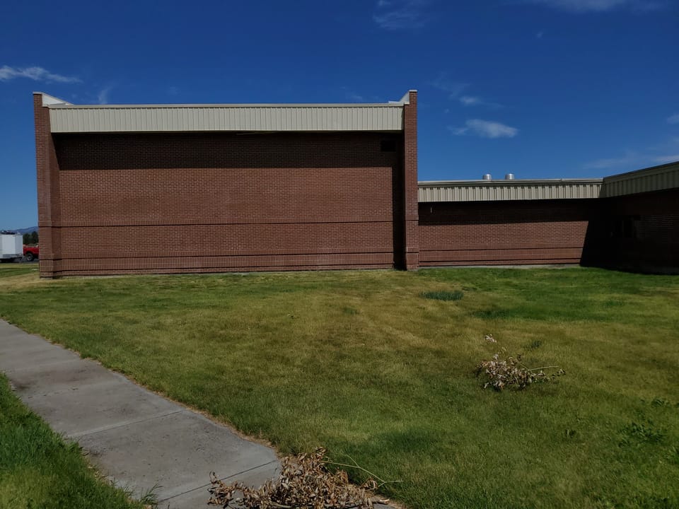 Cleaned brick gym wall at Swan Valley School, uniform red brick with the staining gone